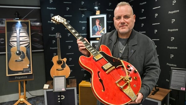 Mark Hochman, Music Consignments Consultant for Propstore, is seen with Noel Gallagher's 1960 Cherry Red Gibson ES-355 Guitar, damaged by Liam Gallagher the night Oasis split up in Paris in August 2009, during the Propstore music memorabilia auction photo