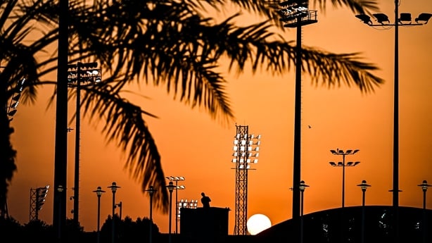 The sun goes down behind a technician at the Aspire Academy Doha, in Doha, at sunset, on November 27, 2022, during the Qatar 2022 World Cup football tournament. (Photo by CHANDAN KHANNA / AFP) (Photo by CHANDAN KHANNA/AFP via Getty Images)
