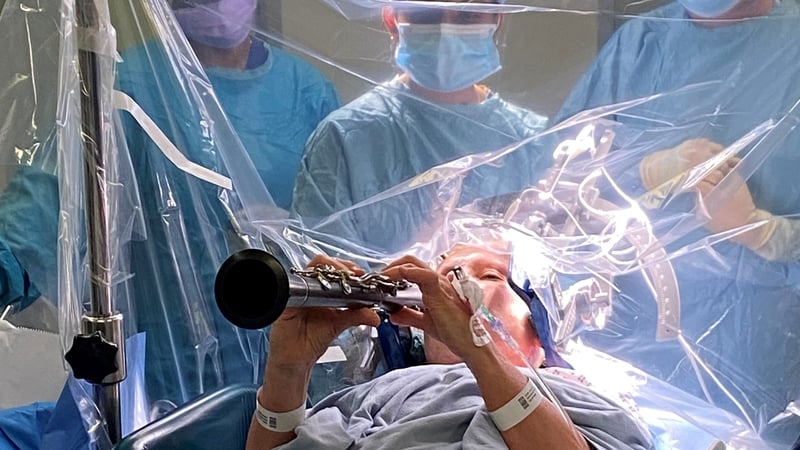 Parkinson's patient Denise Bacon playing the clarinet while undergoing deep brain stimulation