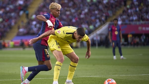 BARCELONA, SPAIN - MAY 18: Lamine Yamal of FC Barcelona competes for the ball with Santi Comesana of Villarreal CF during the LaLiga match between FC Barcelona and Villarreal CF at Estadi Olimpic Lluis Companys on May 18, 2025 in Barcelona, Spain. (Photo