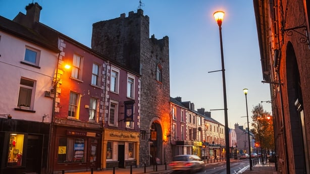 Main street of Cashel, Ireland at night with bars and restaurants. 