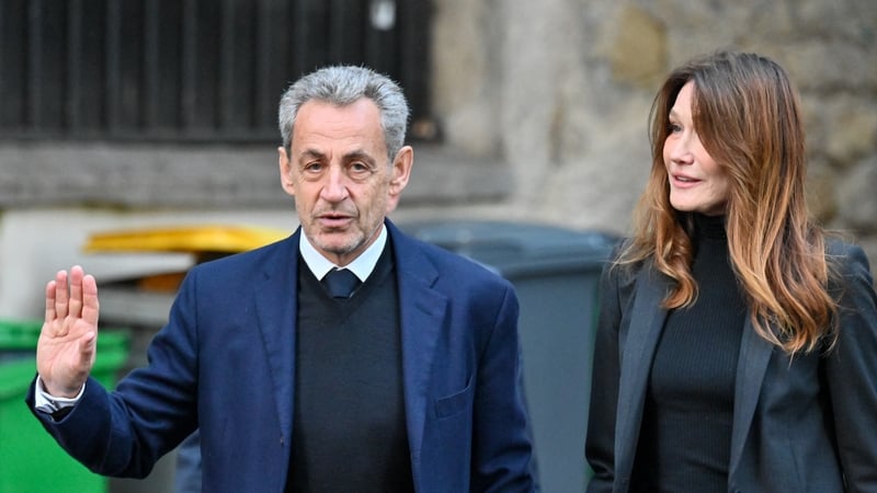 Nicolas Sarkozy pictured with his wife Carla Bruni ahead of his arrival at the prison