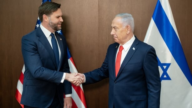 JD Vance shakes hands with Benjamin Netanyahu with American and Israel flags in the background