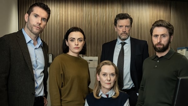 The CAB team - Liam, Claire, Norah, Dunlop, and Sean. Actors: Dónall Ó Héalai, Nora-Jane Noone, Cathy Belton, Steve Wall, Aaron Monaghan Photo Credit: Sofie Van Mieghem/AcornTV & Saffron Moon Ltd 2025