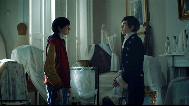 A boy in an old hotel room with an identical doppelganger