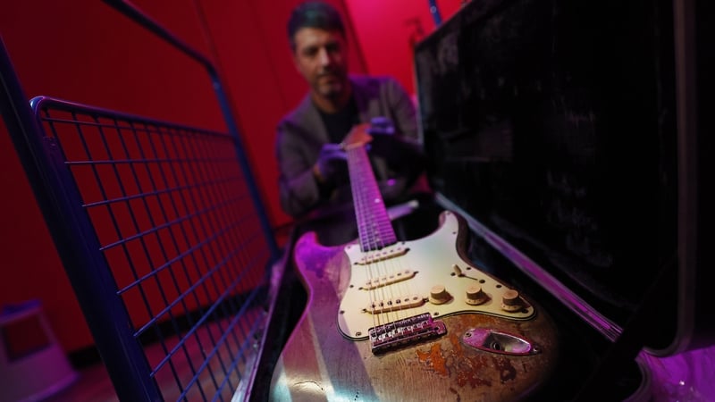 Dónal Maguire from the National Museum of Ireland with Rory Gallagher's Fender Stratocaster (Pic: Julien Bethal)