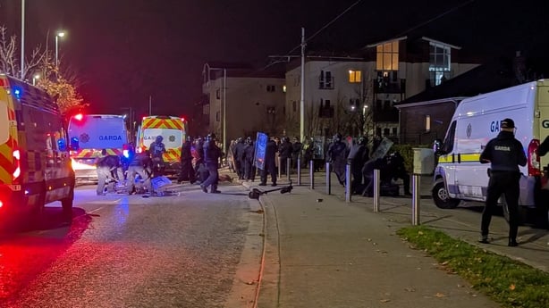 gardai with riot shields, garda vans