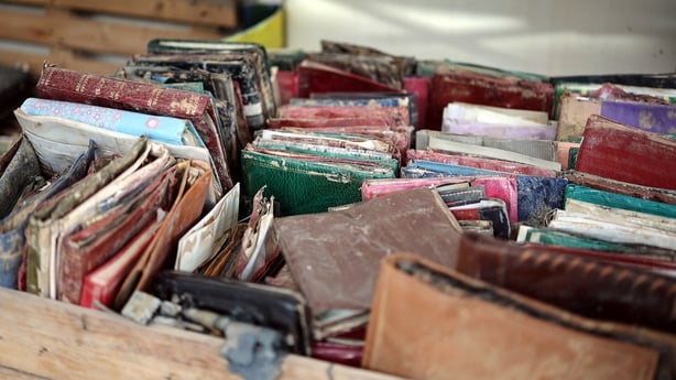A close up image of damaged wallets and purses of various different colours