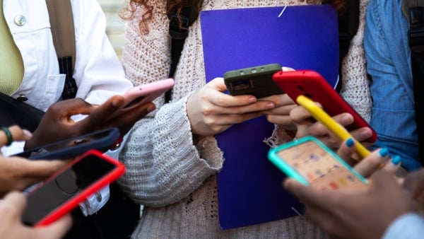 Close up of teenagers holding mobile phones