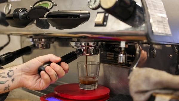 A barista working at a coffee machine