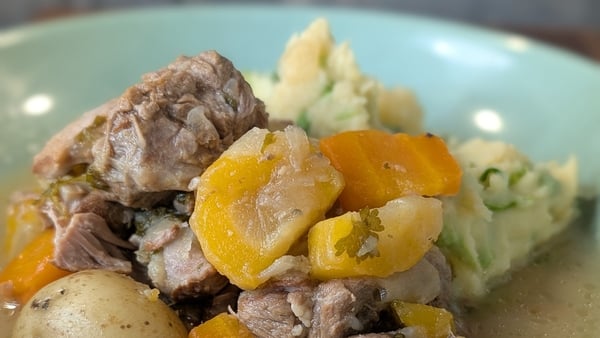 A bowl of traditional Irish stew with mashed potato and carrots