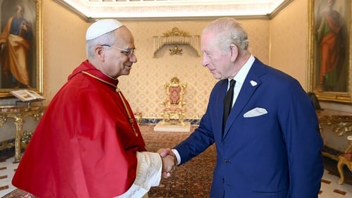 Pope Leo shakes hands with King Charles during an audience at the Apostolic Palace