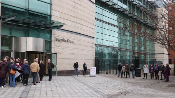 Supporters of Soldier F (right) and family members of Bloody Sunday victims (left) arrive at Belfast Crown Court