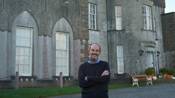 A man smiles as he poses in front of Ardgillan Castle