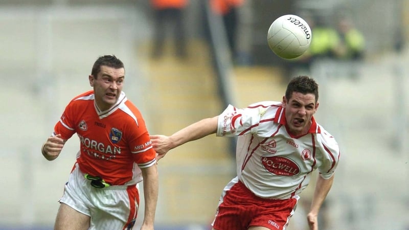 Mickey McGee (R) keeps pace with Armagh Oisín McConville in the 2005 All-Ireland semi-final
