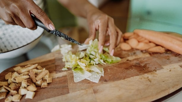 African American woman preparing Caesar Salad