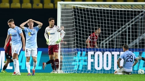 Jonathan Lunney has his hands on his head and a dejected Patrick Barrett is on his knees after Shelbourne's own goal