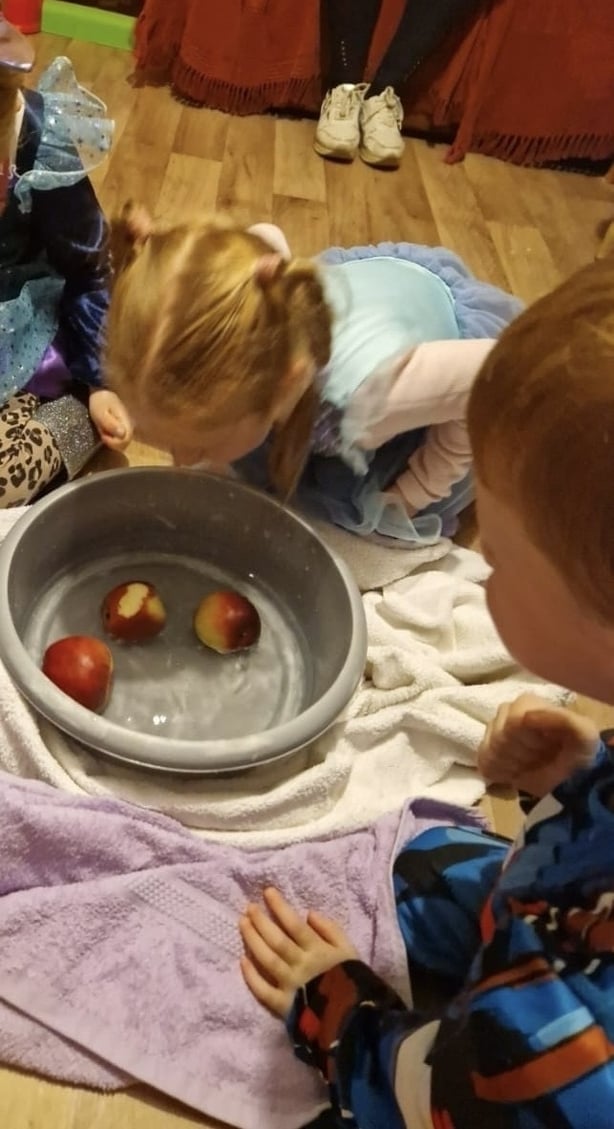 Caoilinn Ní Choincheanainn agus a deartháir Ferdia ag spraoi le húlla Oíche Shamhna in Inis Meáin (grianghraf: Adrian Ó Coincheanainn)