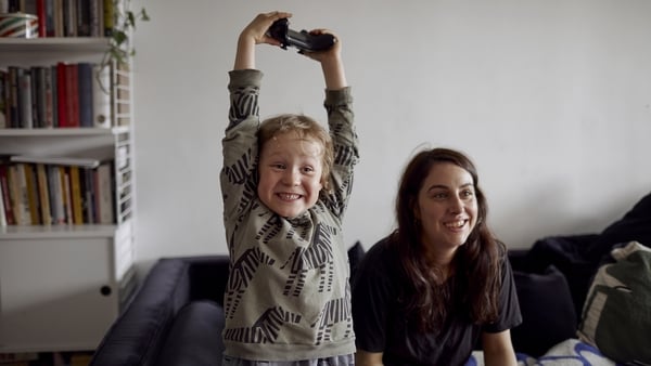 Child and mother happy playing a video game