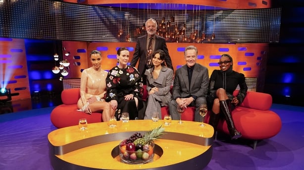 Host Graham Norton with (left to right seated) Kim Kardashian, Sarah Paulson, Rachel Zegler, Bryan Cranston, and Little Simz during filming for the Graham Norton Show