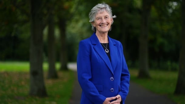 Catherine Connolly smiling, in a park