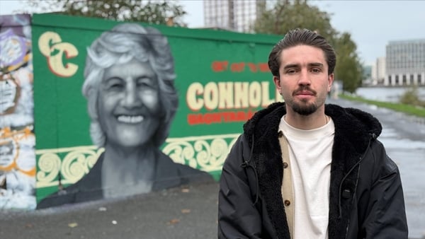 A young man stands in front of a street art mural in Dublin depicting Catherine Connolly A young man stands in front of a street art mural in Dublin depicting Catherine Connolly