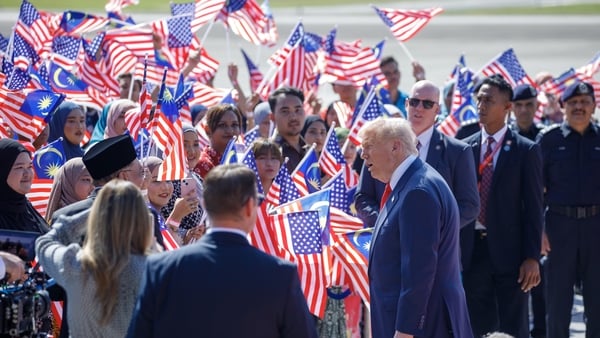 US President Donald Trump speaks to Malaysia's prime ministe at Kuala Lumpur International Airport.