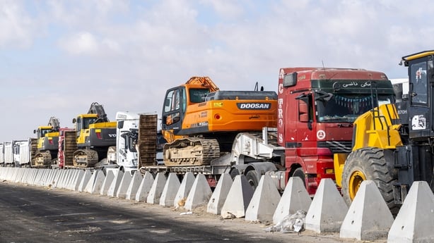 Bulldozers line up in front of the Rafah border crossing waiting to enter the Gaza Strip on October 26, 2025 in Rafah, Egypt. Egypt has sent search-and-rescue equipment and personnel to the Gaza Strip to aid the search for the deceased Israeli hostages who remain in the territory. The next phase of