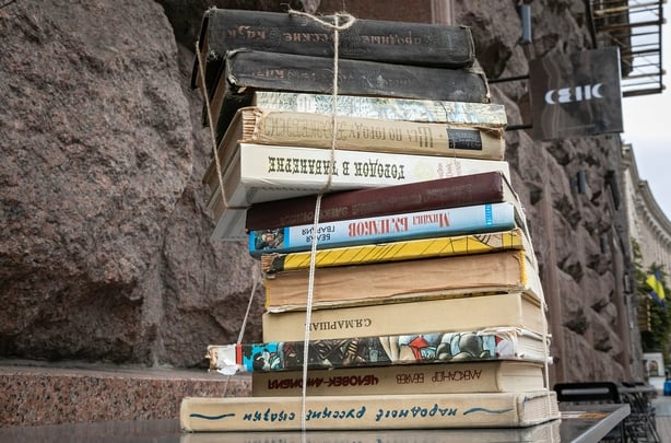 KYIV, UKRAINE - JULY 30, 2024 - A bundle of Russian books is outside the Sens on Khreshchatyk bookshop, Kyiv, capital of Ukraine. In cooperation with No Waste Ukraine NGO and Hurkit Fund, the bookshop expects to raise money from recycling those books to buy the MECHATRONICS mobile air defence statio