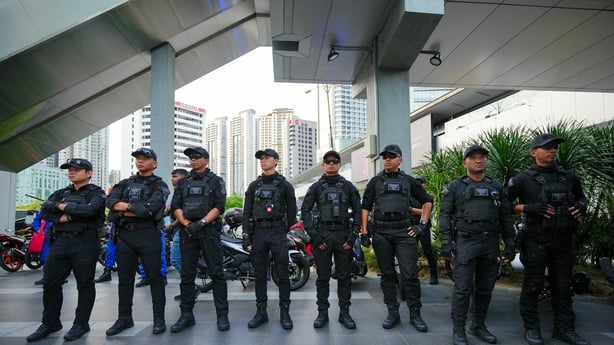 Police officers stand guard
