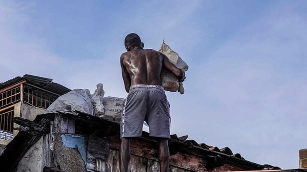 A man attempts to secure the roof of his home ahead of the arrival of Hurricane Melissa in Santiago de Cuba, Cuba