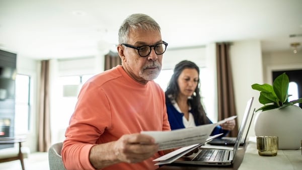 Senior couple payings bills inside home