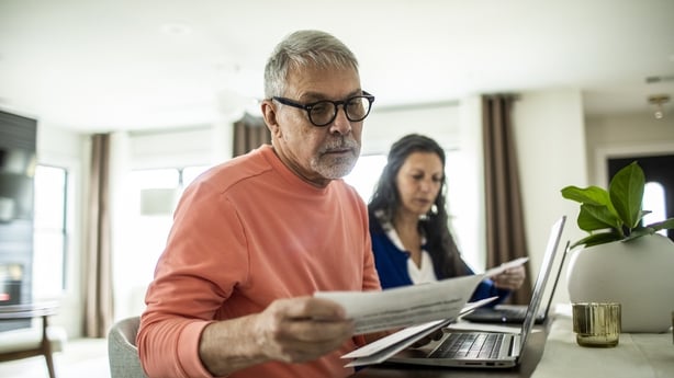 Senior couple payings bills inside home