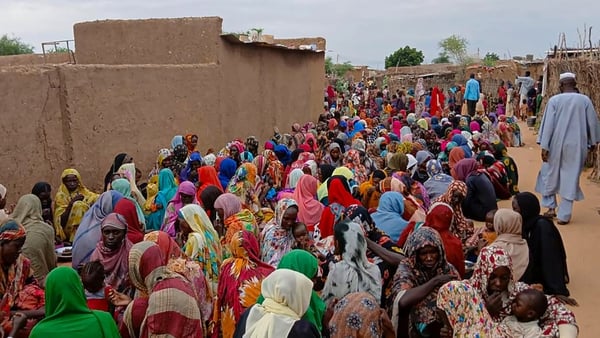 Sudanese residents gather to receive free meals in Al Fasher, a city besieged by Sudan's paramilitary Rapid Support Forces for more than a year