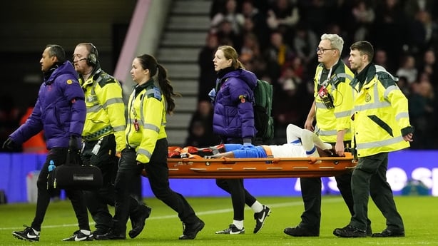 England's Michelle Agyemang reacts as she is carried off the pitch on a stretcher by medical staff