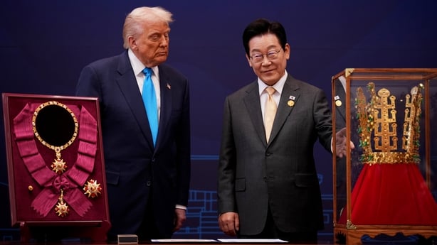Donald Trump reacts as he is presented with the Grand Order of Mugunghwa and the Silla gold crown