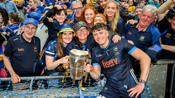 20 July 2025; Tipperary goalkeeper Rhys Shelly celebrates with the Liam MacCarthy cup and family after the GAA Hurling All-Ireland Senior Championship final match between Cork and Tipperary at Croke Park in Dublin. Photo by Stephen McCarthy/Sportsfile