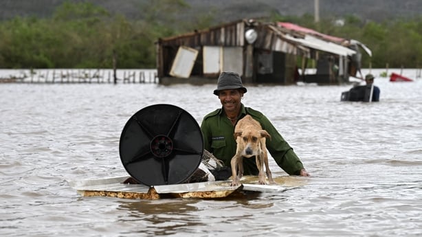 A farmer rescues his dog in Cuba after flooding brought by the hurricane