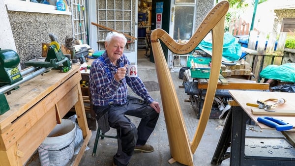 89 year old Harp maker Noel Anderson poses for a portrait at his home workshop in Strabane