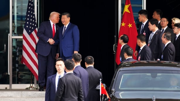 US President Donald Trump and Chinese President Xi Jinping shake hands as they depart a bilateral meeting in South Korea