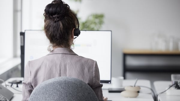A businesswoman sitting at an office desk A businesswoman sitting at an office desk
