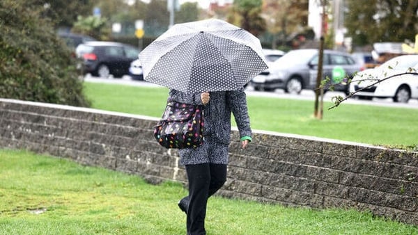 A woman walking with an umbrella