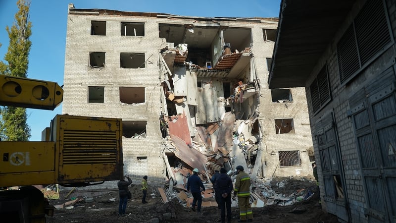 Rescuers stand in front of partially destroyed residential building after a Russian attack on Zaporizhzhia, Ukraine