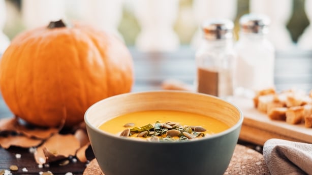 Close-up on a earthenware bowl with a creamy pumpkin soup