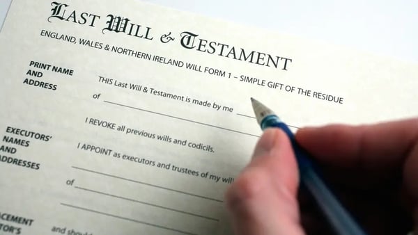 Close up of a hand signing a last will and testament