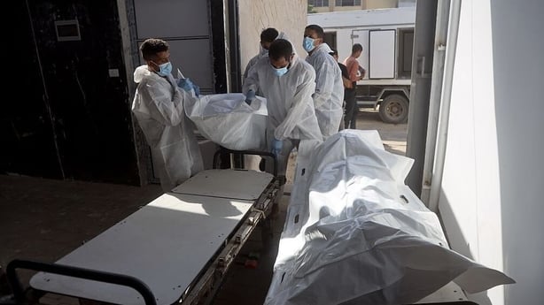 Red Cross teams deliver the bodies of 30 Palestinians
