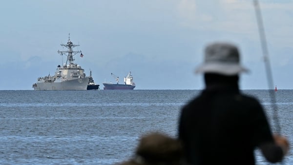 The USS Gravely warship is seen at a distance off the coast of Port of Spain on October 26, 2025, as fishermen look from the Trinidadian capital. The US warship will visit Trinidad and Tobago for joint exercises near the coast of Venezuela amid Washington The USS Gravely warship is seen at a distance off the coast of Port of Spain on October 26, 2025, as fishermen look from the Trinidadian capital. The US warship will visit Trinidad and Tobago for joint exercises near the coast of Venezuela amid Washington