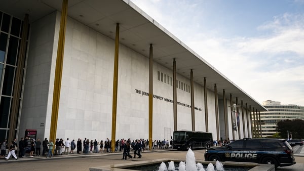 People wait in line prior to a prayer vigil for political activist Charlie Kirk outside the John F Kennedy Center for the Performing Arts