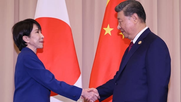 Japan's Prime Minister Sanae Takaichi shakes hands with Chinese President Xi Jinping