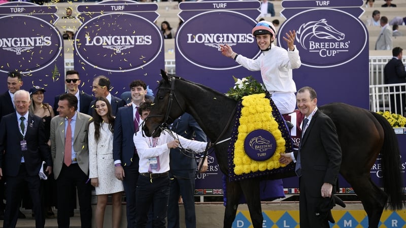 Dylan McMonagle poses for photos after winning the Breeders' Cup Turf race aboard Willie Mullins' Ethical Diamond